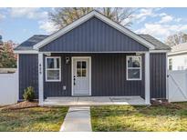 Gray exterior of charming craftsman style home with a covered porch and landscaped yard at 429 Dare Dr, Charlotte, NC 28206