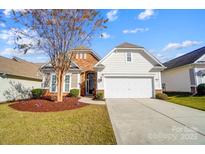 Charming one-story home featuring a well-manicured lawn and a two-car attached garage at 2221 Hartwell Ln, Fort Mill, SC 29707