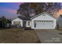 House exterior featuring a two-car garage and landscaping at 4632 Hampton Chase Sw Dr # 20, Concord, NC 28027