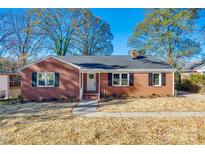 Brick ranch house with a white door, landscaping, and a spacious yard at 1081 Evergreen Cir, Rock Hill, SC 29732