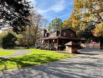 Charming two-story home with a covered porch and well-maintained lawn at 13538 Pine Harbor Rd, Charlotte, NC 28278