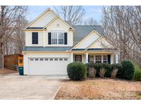 Charming two-story home with a well-maintained lawn and two-car garage at 141 Byers Rd, Troutman, NC 28166