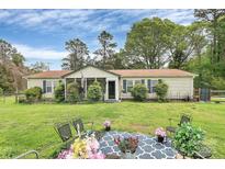 Charming home featuring a lush lawn and a cozy screened-in porch area at 335 Ridgewood Dr, Mt Ulla, NC 28125