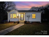 Charming white bungalow with a well-manicured lawn and walkway at 109 Stonecrest Sw Cir, Concord, NC 28027