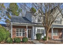 Brick townhouse with a landscaped front yard at 14922 Deshler Ct, Charlotte, NC 28273