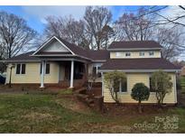 Charming two-story home featuring a well-manicured front yard, inviting curb appeal, and great natural light at 16425 Grapperhall Dr, Huntersville, NC 28078
