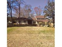 Charming ranch-style home with a welcoming front porch and mature trees on a large lot at 16425 Grapperhall Dr, Huntersville, NC 28078