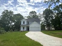 Charming two-story home with a well-manicured lawn and attached two-car garage at 168 Wildwood Loop, Statesville, NC 28625