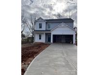 Two-story house with gray siding, a white trim, and a two-car garage at 168 Wildwood Loop, Statesville, NC 28625