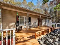 Inviting front porch featuring rocking chairs and seasonal decor at 25040 Timberlake Dr, Tega Cay, SC 29708