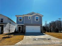 Charming two-story home featuring a two-car garage, gray siding, and a well-manicured front lawn at 1204 31St St, Conover, NC 28613