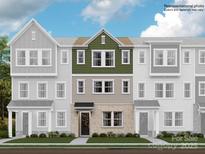 Three-story townhome with green and beige exterior at 4068 Skyboat Cir, Fort Mill, SC 29715