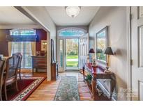 Bright entryway with hardwood floors, and view to backyard at 8420 Locksley Dr, Harrisburg, NC 28075