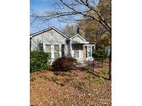 Charming single-Gathering home features a cozy front yard with mature landscaping and a classic design at 805 Railroad Ave, China Grove, NC 28023