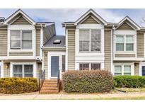 Charming two-story townhome with a brick entryway and well-maintained landscaping, creating a welcoming curb appeal at 8218 Legare Ct, Charlotte, NC 28210