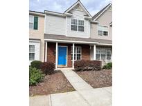 Two-story townhome with brick facade, blue door, and small front yard at 13660 Meade Glen Ct, Charlotte, NC 28273