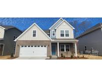 Charming two-story home featuring a brick facade, attached garage, and inviting front porch at 159 Ella Claire Dr, York, SC 29745