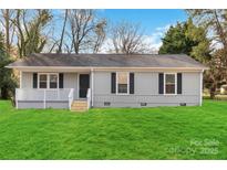 Charming single-story home featuring a well-manicured lawn and a welcoming front porch at 1637 Sumner Dr, Rock Hill, SC 29732