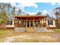 House exterior featuring a covered porch, landscaped yard, and shed at 4450 Dobys Bridge Rd, Fort Mill, SC 29707