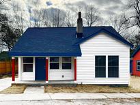 Charming white house with blue accents and a dark blue roof at 123 Oak St, Chester, SC 29706