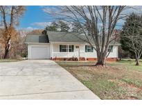 Charming single-story home with white siding, a covered front porch, and a well-maintained front yard at 161 Westscott Dr, Statesville, NC 28625