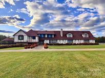 Charming two-story home with mature landscaping and manicured lawn at 4556 Harley Davidson Dr, Catawba, NC 28609