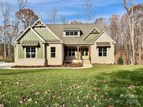 Charming brick home with green trim, a well-manicured lawn, and inviting curb appeal at 959 Tamary Way # 29/30, Landis, NC 28088