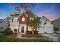 Brick two-story house with a two-car garage and landscaping at 124 Harris Farm Rd, Mooresville, NC 28115