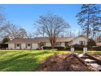 Charming single-story home featuring a well-maintained lawn, brick walkway, and a classic, neutral exterior paint scheme at 946 Scotch Dr, Gastonia, NC 28054