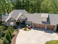An elevated view showcasing the home's roof, three car garage, driveway, and meticulously landscaped front yard at 1140 Inlet Pointe Rd, Salisbury, NC 28146