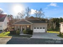 Craftsman style home with two-car garage and landscaped yard at 310 Pine St, Locust, NC 28097