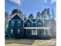 Two-story home with dark siding, white trim, and a front porch at 357 Triple Ponds Ct, Clover, SC 29710
