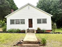Charming single-story home featuring a well-manicured front yard and welcoming entrance at 155 6Th Sw St, Taylorsville, NC 28681