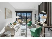 Bright living room with balcony access, hardwood floors, and modern furnishings at 819 E 36Th St, Charlotte, NC 28205