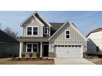 Charming two-story home with a white garage door and neutral siding at 1063 Bull Dog Ln, Wingate, NC 28174
