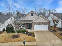 Well-maintained two-story home with brick and siding, attached garage, and landscaped front yard at 2481 Bergamot St, Tega Cay, SC 29708