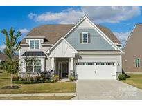 Two-story house with gray siding, white garage door, and landscaping at 4015 Havenport Cir, Tega Cay, SC 29708