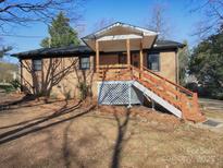 Brick ranch house with a wooden deck and stairs at 5315 Ruth Dr, Charlotte, NC 28215
