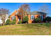 Brick house with landscaping, a walkway, and a double-door entry at 5839 Painted Fern Ct, Charlotte, NC 28269