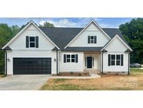 Charming new construction home featuring a white exterior, black shutters, and a spacious two-car garage at 5037 Faith Rd, Salisbury, NC 28146