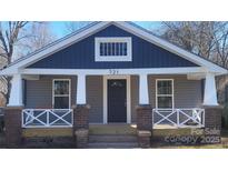 Charming craftsman style home featuring gray and blue siding, a front porch, and brick accents at 721 N Salisbury Ave, Spencer, NC 28159