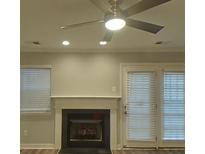 Cozy living room featuring a fireplace and a ceiling fan at 1826 Birch Heights Ct, Charlotte, NC 28213