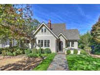 Charming stucco home with stone walkway, landscaping, and a spacious front yard at 2408 Westfield Rd, Charlotte, NC 28207