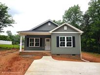 Charming craftsman-style home with gray siding, black shutters, and a well-manicured front yard at 1589 Maysville Rd, Shelby, NC 28150