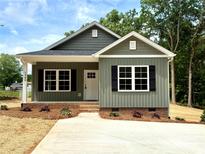 Charming single-Gathering home showcasing a well-manicured lawn and a delightful covered porch at 1589 Maysville Rd, Shelby, NC 28150