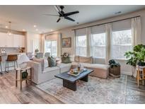 Spacious living room with light beige sectional sofa and large windows at 2123 Belterra Dr, Charlotte, NC 28216