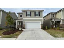 Two-story home with neutral siding, black shutters, two-car garage, and a well-maintained lawn at 3033 Eastcott Ave, Monroe, NC 28110