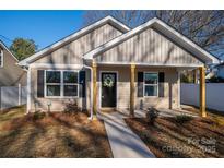 New construction home with tan siding, a black door, and a walkway at 511 E Sycamore St, Lincolnton, NC 28092