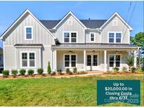 Charming two-story home with gray siding, black roof, and manicured front lawn showcasing closing cost promotion at 1875 Rock Hill Church Rd # 4, Matthews, NC 28104