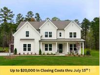 Beautiful white two-story home with black trim, lush lawn, and inviting front porch at 1875 Rock Hill Church Rd # 4, Matthews, NC 28104